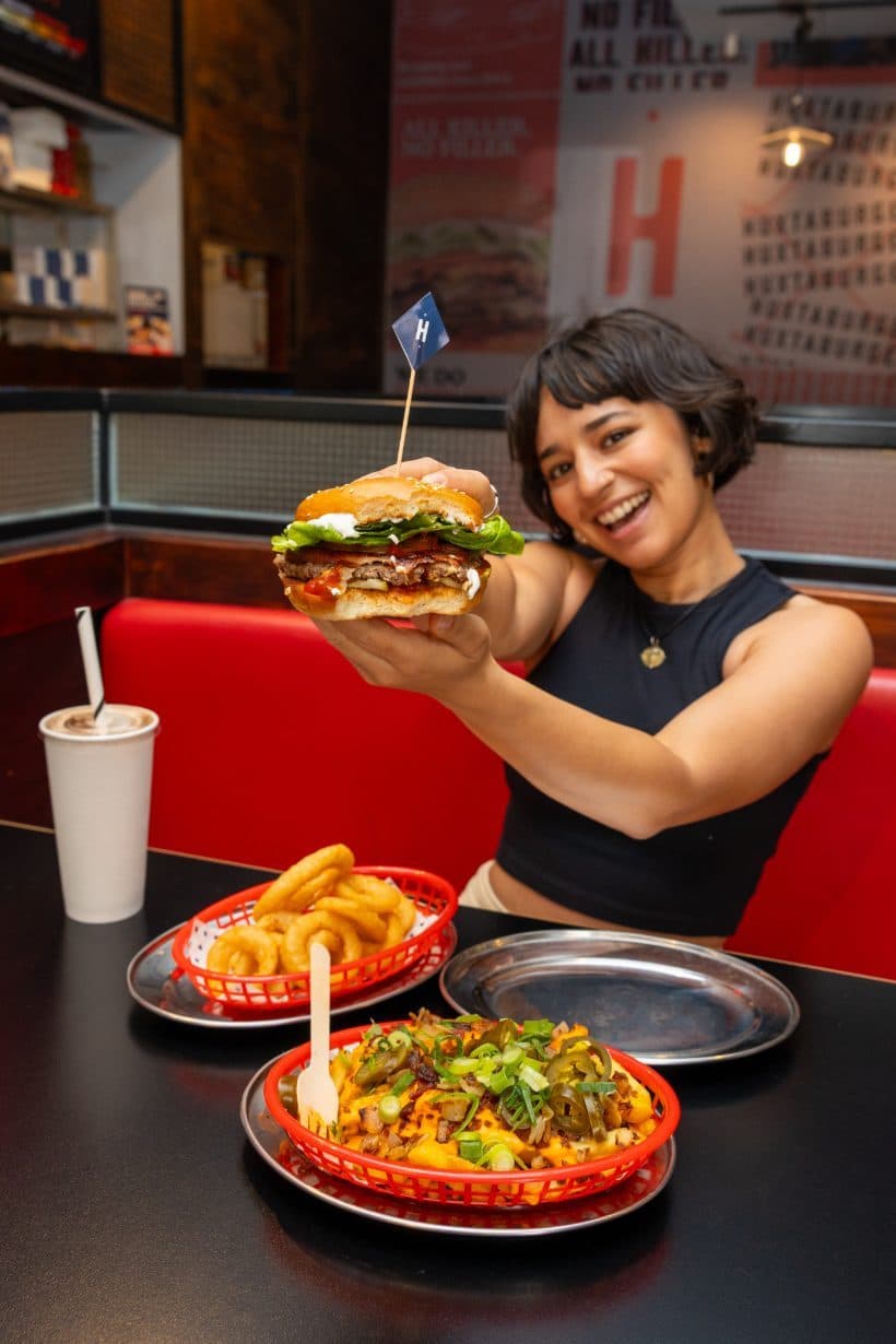 Customer holding a Huxtaburger